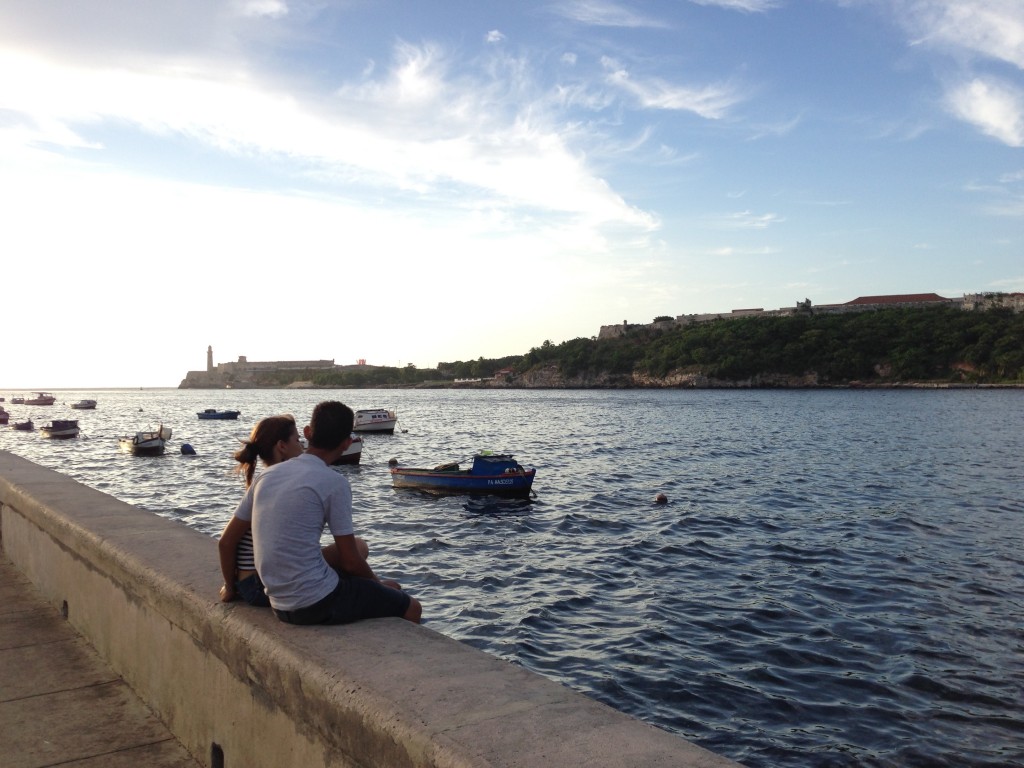 A couple admires the view from the Malecón. 